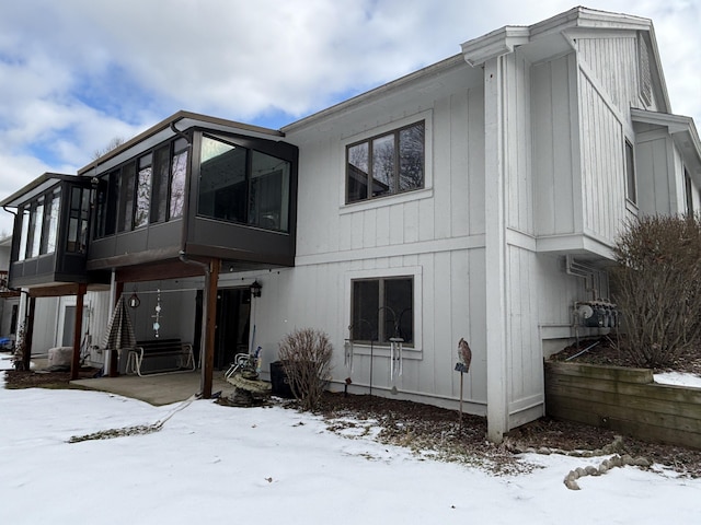 view of snow covered rear of property