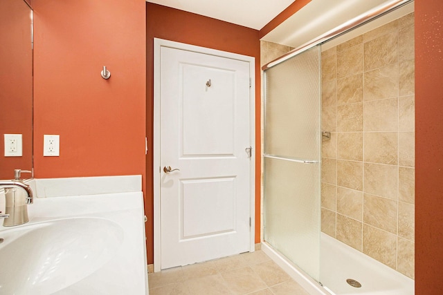 bathroom with tile patterned flooring, sink, and walk in shower