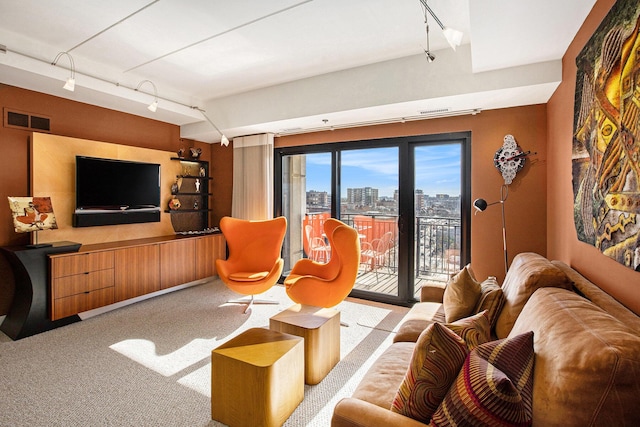 living room with track lighting and light colored carpet