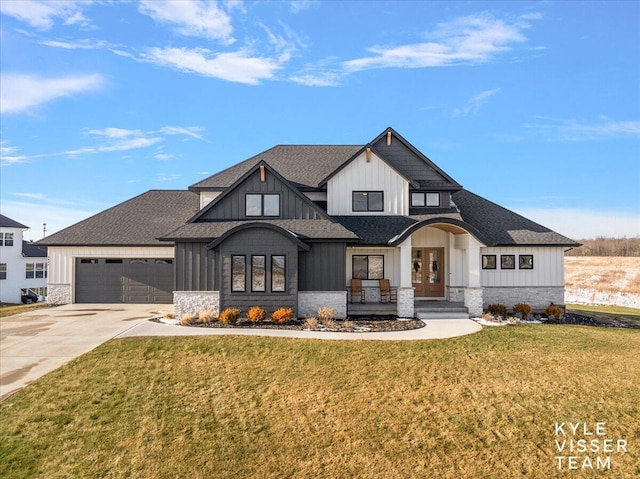 modern inspired farmhouse with a garage and a front yard