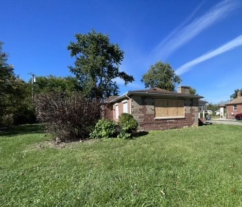 view of side of property with a yard