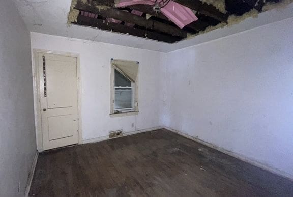 spare room with dark wood-type flooring