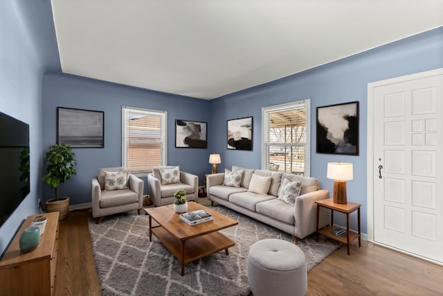 living area with wood finished floors and baseboards