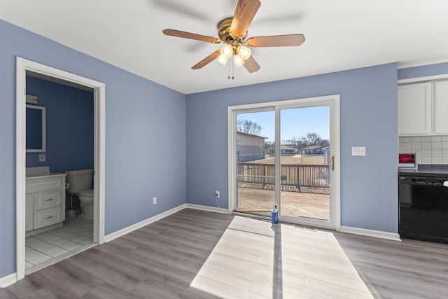 dining area featuring a ceiling fan, baseboards, and wood finished floors