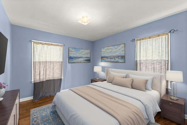 bedroom with multiple windows, wood finished floors, and baseboards