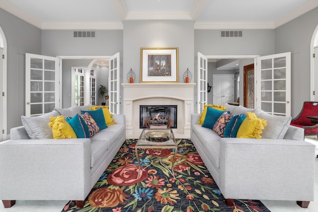 carpeted living area with visible vents, crown molding, and french doors