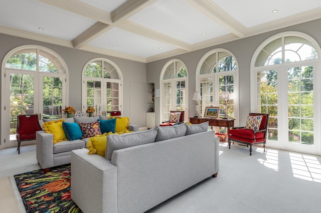 sunroom with beamed ceiling, a healthy amount of sunlight, and french doors