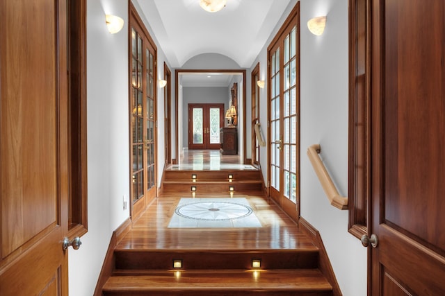 hall featuring baseboards and french doors