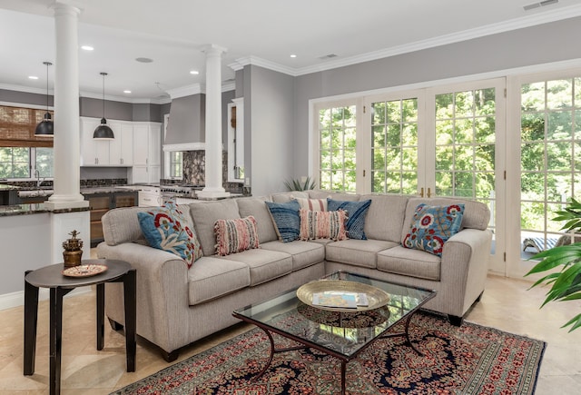 living area featuring visible vents, recessed lighting, and ornate columns