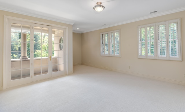 empty room with carpet floors, visible vents, baseboards, and ornamental molding