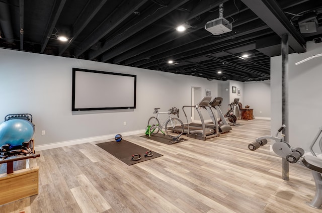 exercise room with baseboards and wood finished floors