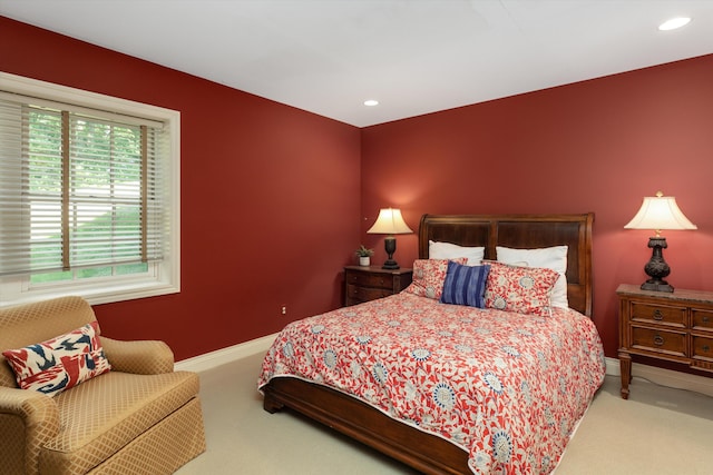 carpeted bedroom featuring baseboards and recessed lighting