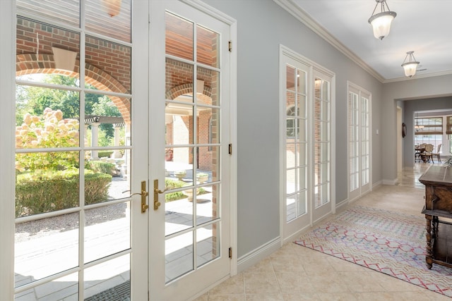 entryway with tile patterned floors, french doors, baseboards, and ornamental molding