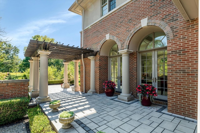 view of patio featuring a pergola and french doors