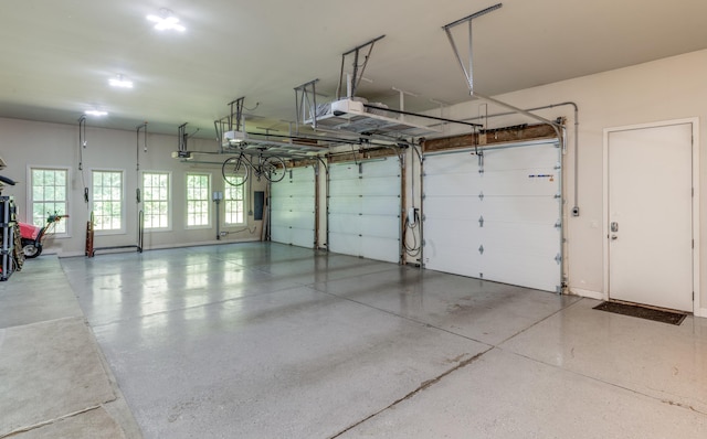 garage with baseboards and a garage door opener