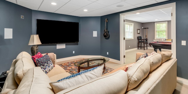 living room with baseboards, pool table, and a drop ceiling
