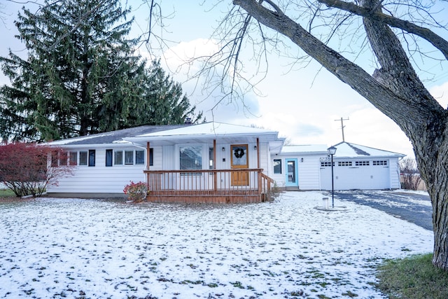 ranch-style house with a garage and a porch