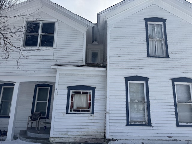 view of side of home with covered porch