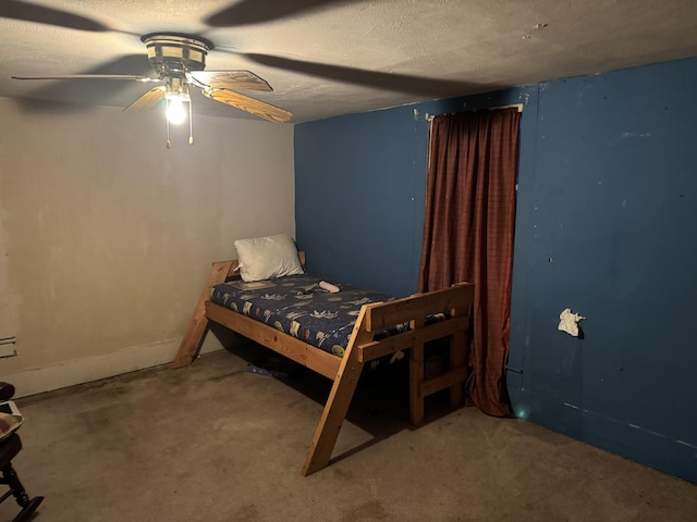 carpeted bedroom featuring ceiling fan and a textured ceiling