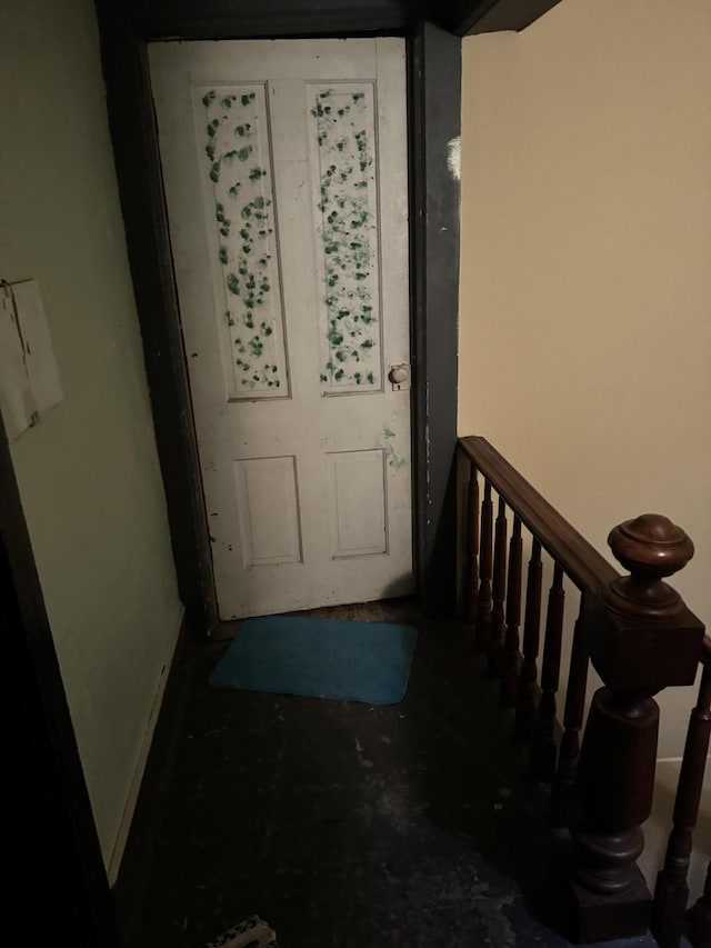 doorway featuring baseboards and stairs