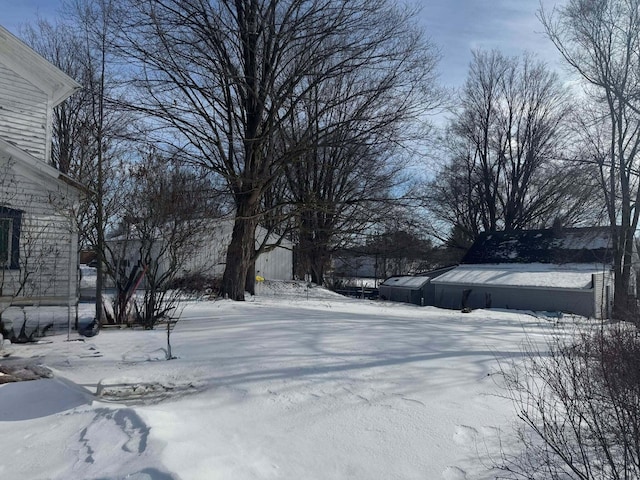 yard layered in snow with an outdoor structure