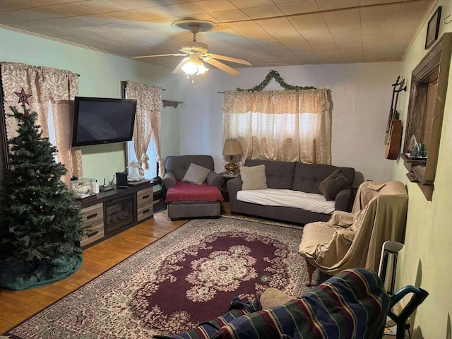 living room with ceiling fan and wood finished floors