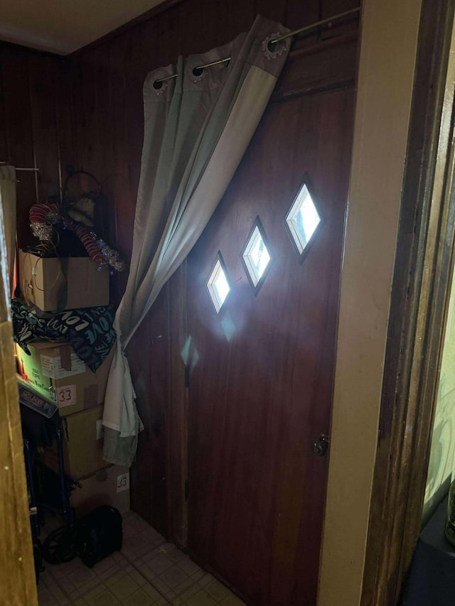 entrance foyer featuring wood walls