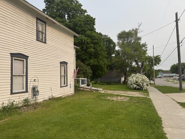313 W 6th St, Evart, MI 49631 - view of property exterior with a yard