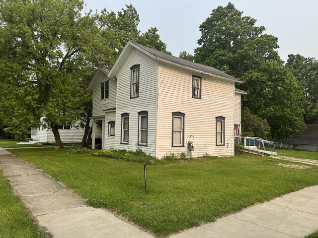 313 W 6th St, Evart, MI 49631 - view of front of home featuring a front yard