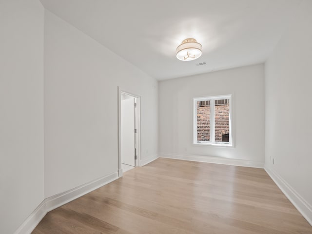 unfurnished room with light wood-type flooring