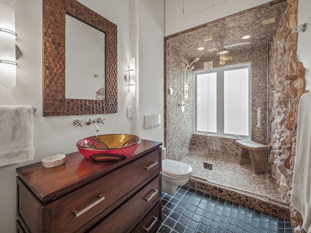 bathroom featuring tiled shower, vanity, and toilet