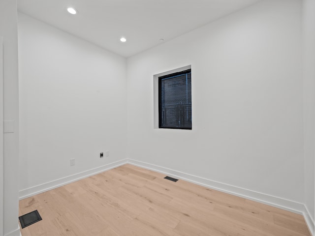 spare room with light hardwood / wood-style flooring