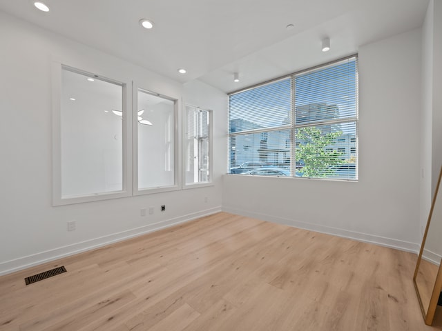 spare room featuring light hardwood / wood-style flooring