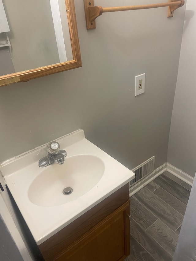 bathroom with vanity and hardwood / wood-style floors