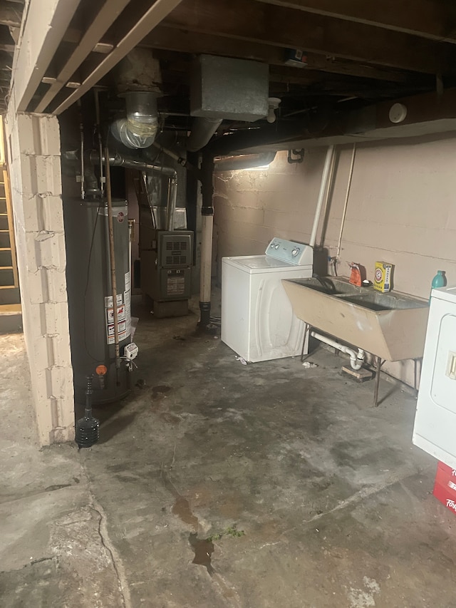 basement with washer / clothes dryer, gas water heater, sink, and heating unit