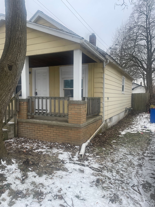 view of snowy exterior with a porch