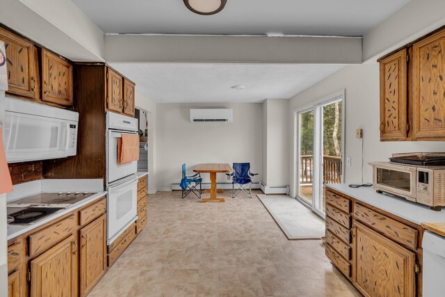 kitchen with white appliances, baseboards, light countertops, and a wall mounted AC