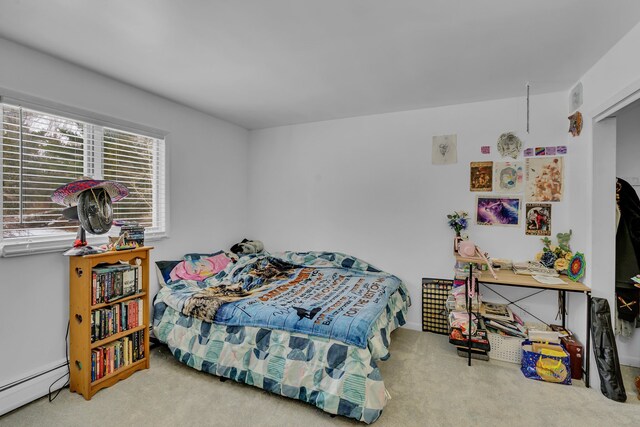 carpeted bedroom with a baseboard radiator