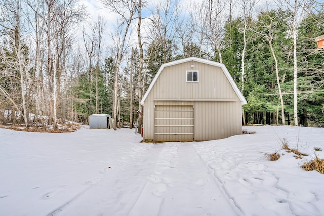 snow covered garage featuring a garage