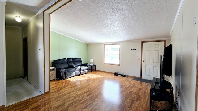 living room featuring hardwood / wood-style floors, crown molding, and a textured ceiling