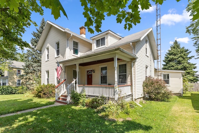 view of front of house featuring covered porch and a front yard