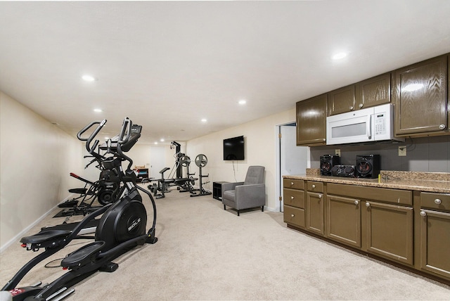 workout room with light colored carpet