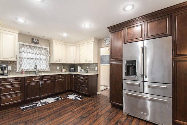 kitchen featuring high quality fridge, dark hardwood / wood-style floors, sink, and decorative backsplash