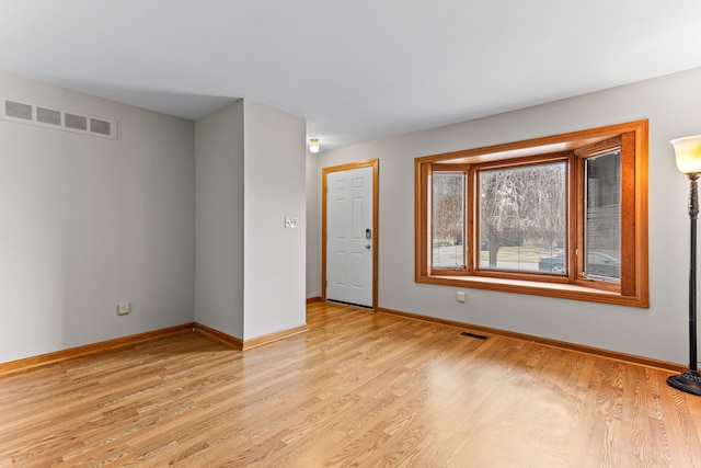 empty room with light hardwood / wood-style flooring