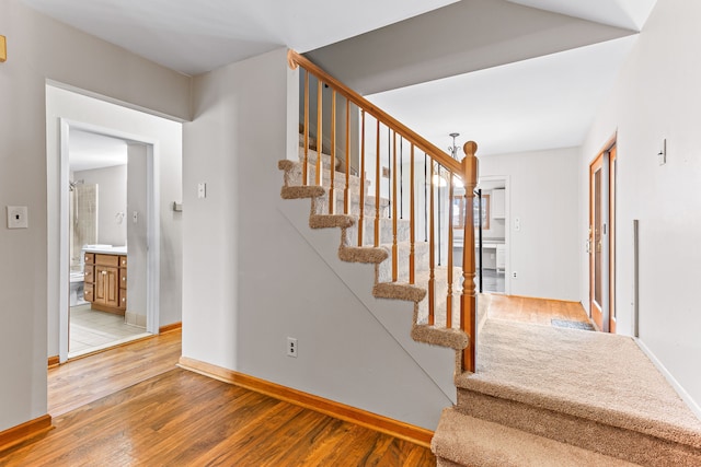 stairs with hardwood / wood-style floors