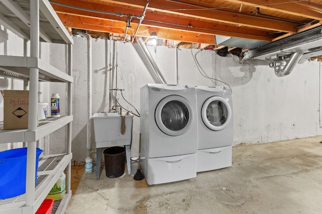 laundry room with washing machine and dryer and sink