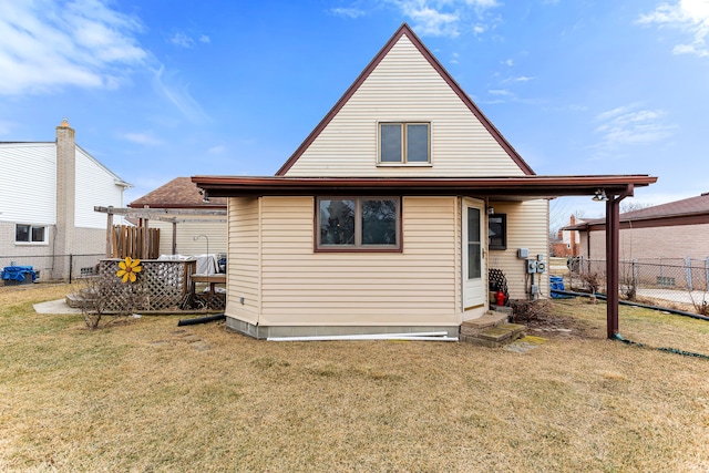 rear view of property with a yard