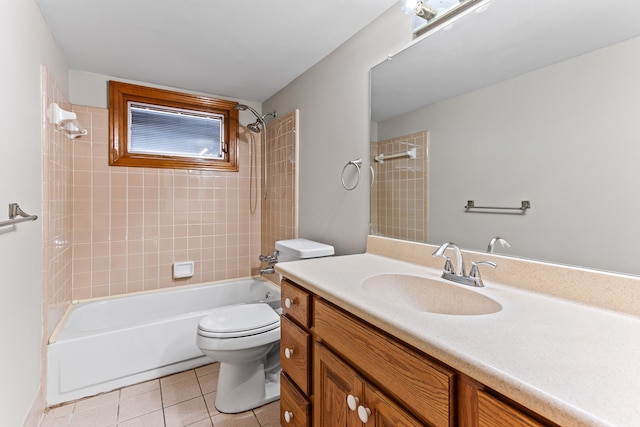 full bathroom featuring tile patterned flooring, vanity, tiled shower / bath combo, and toilet