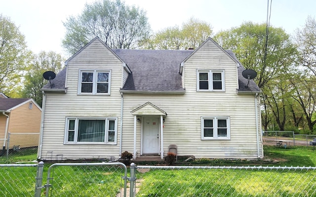 cape cod-style house with a fenced front yard, a shingled roof, and a front lawn