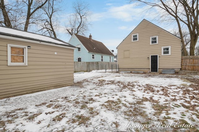 view of snow covered rear of property